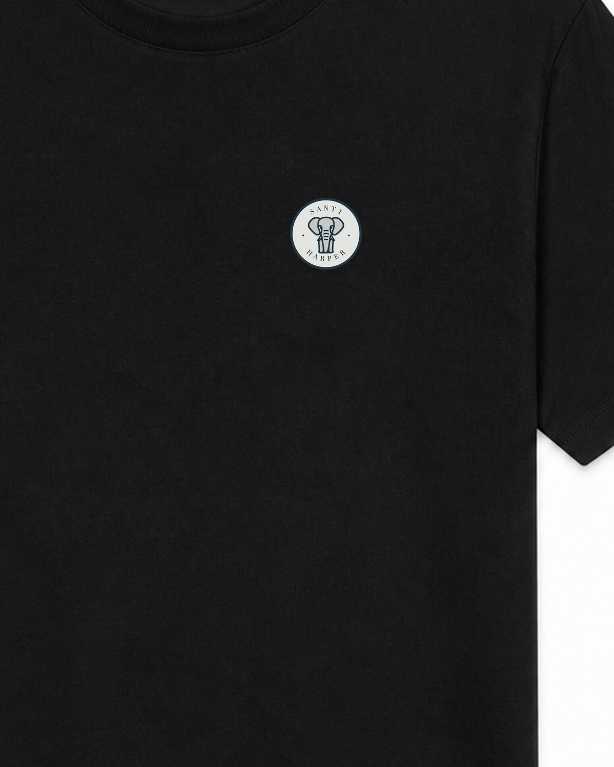 Close-up of the tonal Santi Harper compact elephant badge printed at the left chest