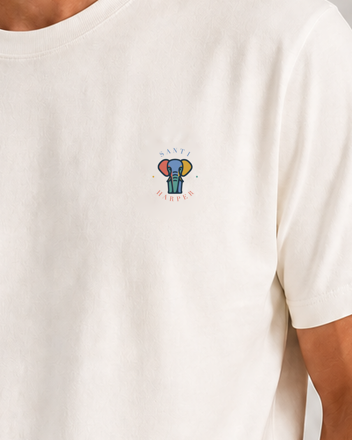 Close-up of the full-colour Santi Harper elephant emblem printed at the left chest