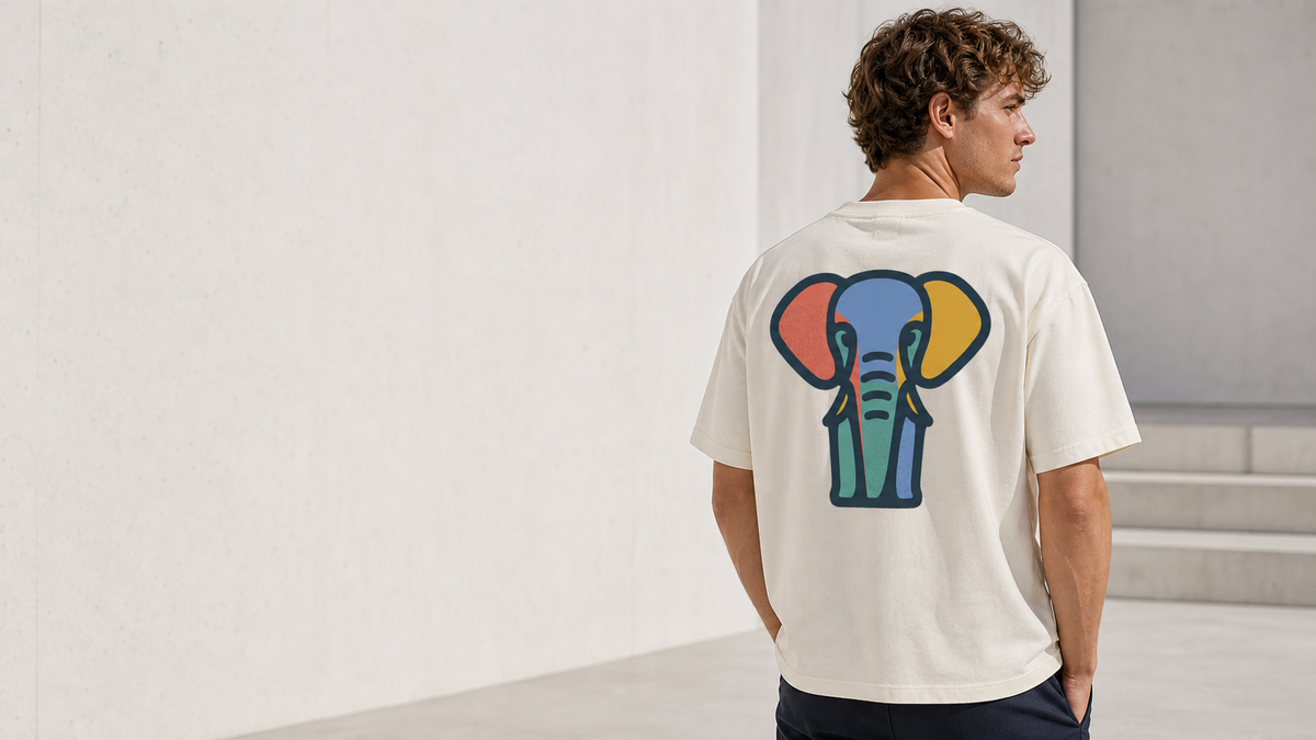 Model wearing a cream Santi Harper T-shirt with colourful elephant back artwork