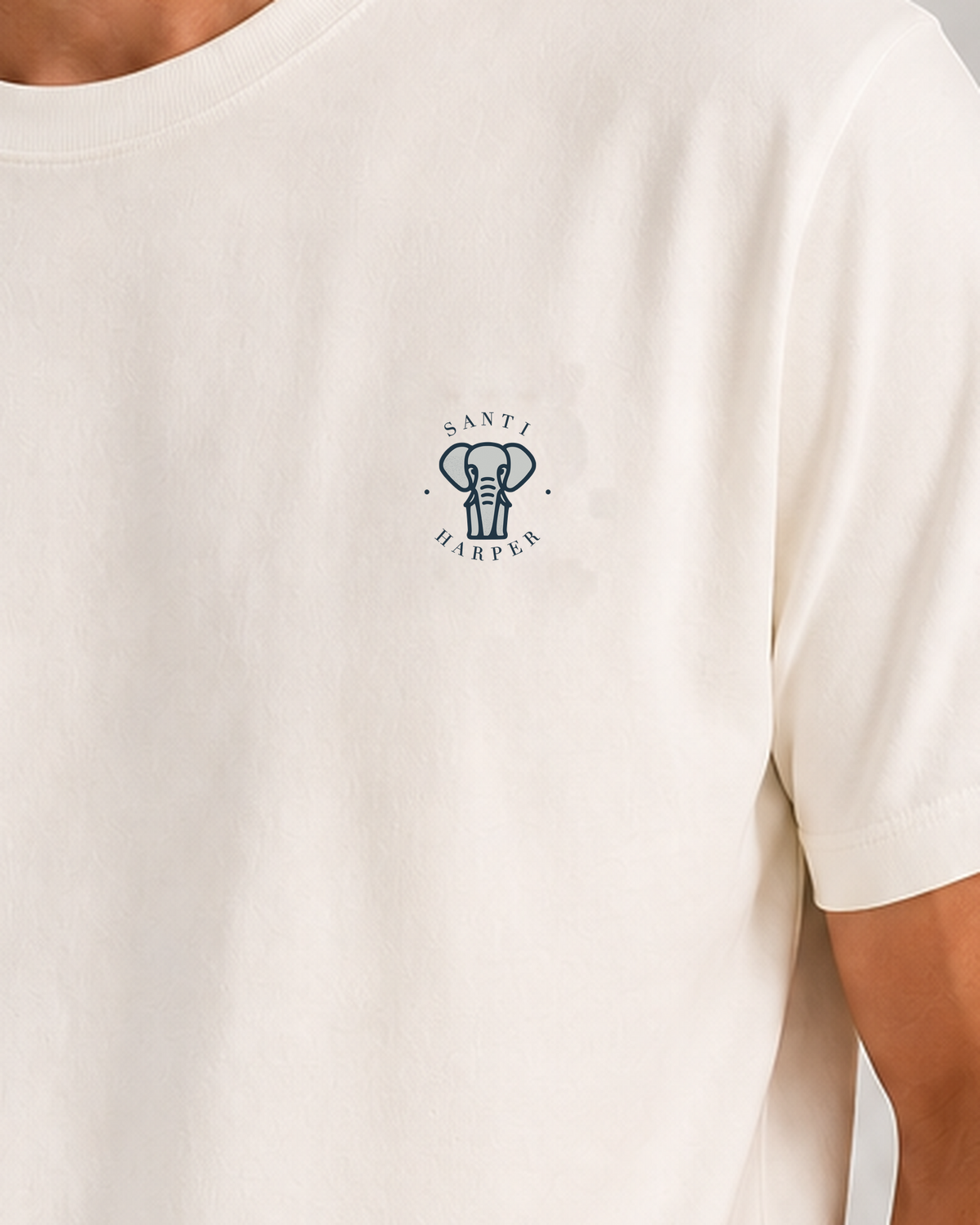 Close-up of the tonal Santi Harper elephant emblem printed at the left chest